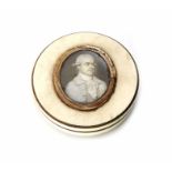 A George III ivory patch box with miniature portrait of a gentleman. 7.5cm diameter.