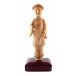 19th century Chinese carved ivory figure in long robe holding single flower stem, height 8cm (inc.