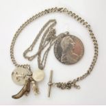 A silver dollar (Mother Theresa) on a chain together with silver fob chain with silver plated charms