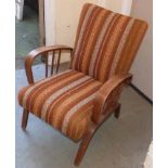 1970's Bentwood classic fireside chair with side spindles having orange and green striped upholstery