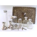 Silver embossed tray, sugar tongues, pen knife, silver candlesticks, six bottles Unfortunately we