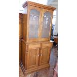 Victorian oak bookcase on base, the upper portion enclosing two arched doors with frosted glass, The