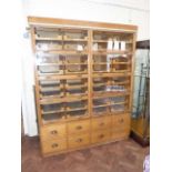 Early 20th century oak haberdashers shop cabinet enclosed 42 slides to upper portion with up and
