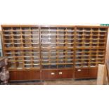 Bank three haberdashery cabinets, being three sections 123cm wide, each section enclosing room for