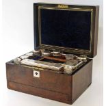 Victorian walnut veneered travel vanity box fitted interior with EPNS topped bottles.