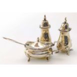 A silver and blue glass lined mustard pot and a pair of salt and pepper shakers, Birmingham 1912,