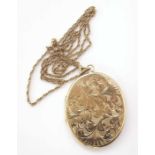 9ct gold large oval scrollwork locket, weight approx. 21.5g. Unfortunately we are not doing