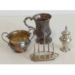 Silver toast rack, pepperette, sugar bowl and embossed mug. Unfortunately we are not doing condition