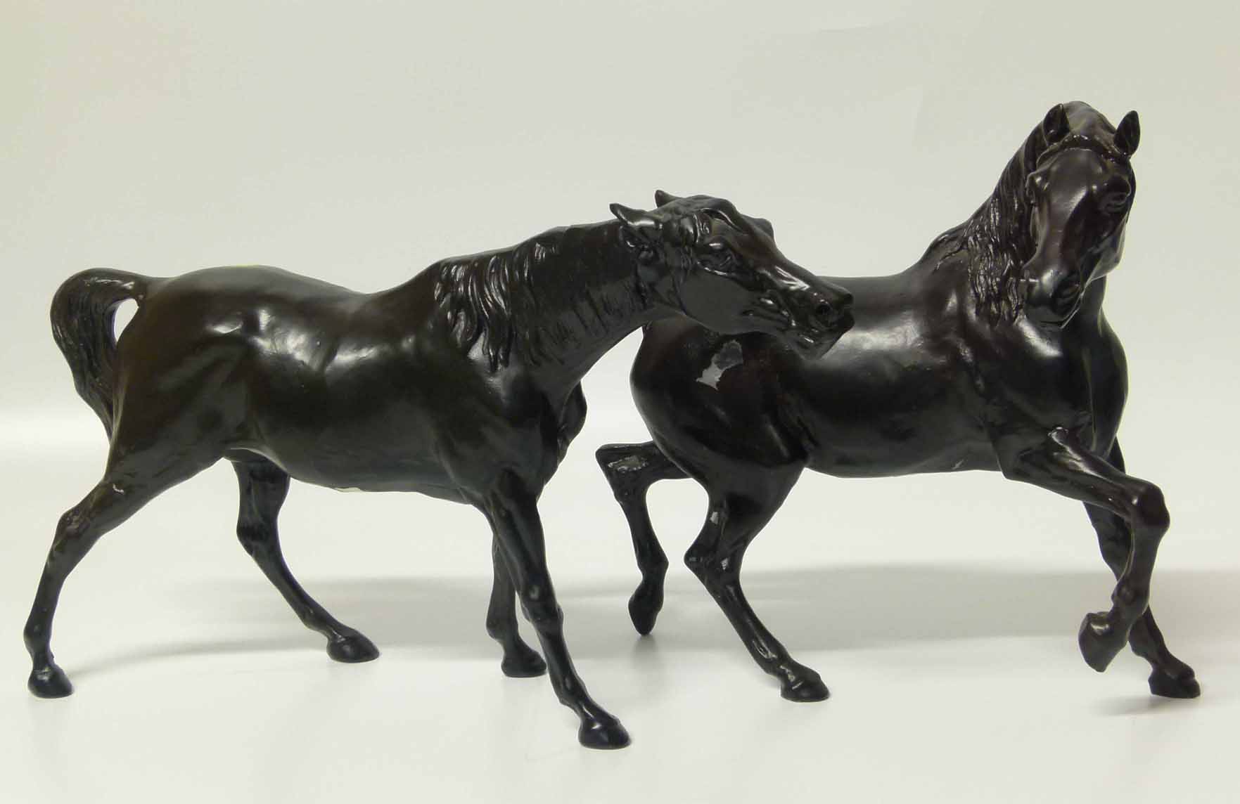 A pair of cast black painted horses Unfortunately we are not doing condition reports on this sale.