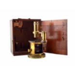 A late Victorian brass microscope, contained in a mahogany travel box with brass handle and hinged