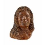 A Native American figure head carved in amber resin. 10.5cm height.