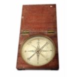 A late 18th century/early 19th century compass with silvered face contained in a mahogany box. By