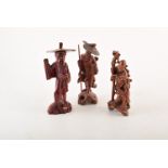 Three Japanese Okimono figures, carved in hardwood depicting three male human figures in various