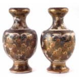 Pair of Japanese Satsuma vases, painted with figures within landscapes, together with wood bases and