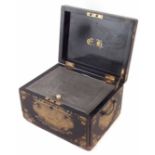 Chinese black lacquer and gilt tea box containing a Chinese lead lidded caddy engraved with figures,