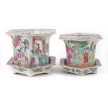 A pair of Cantonese jardinières and stands, of hexagonal form painted with Chinese ladies within