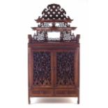 Chinese hardwood table top cabinet, with pierced relief carved shelf frieze, two pierced doors