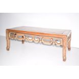 A late 19th century/early 20th Chinese hardwood opium table. With pierced carved frieze on