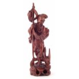 Chinese carved hardwood figure of a fisherman, the figure and fish have applied glass eyes, early