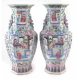 Pair of Cantonese hexagonal vases decorated with Chinese figures in interior scenes, applied dog and