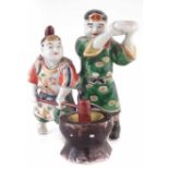 Japanese figure group, modelled Mochi making, late 19th early 20th century, 18cm high. Condition