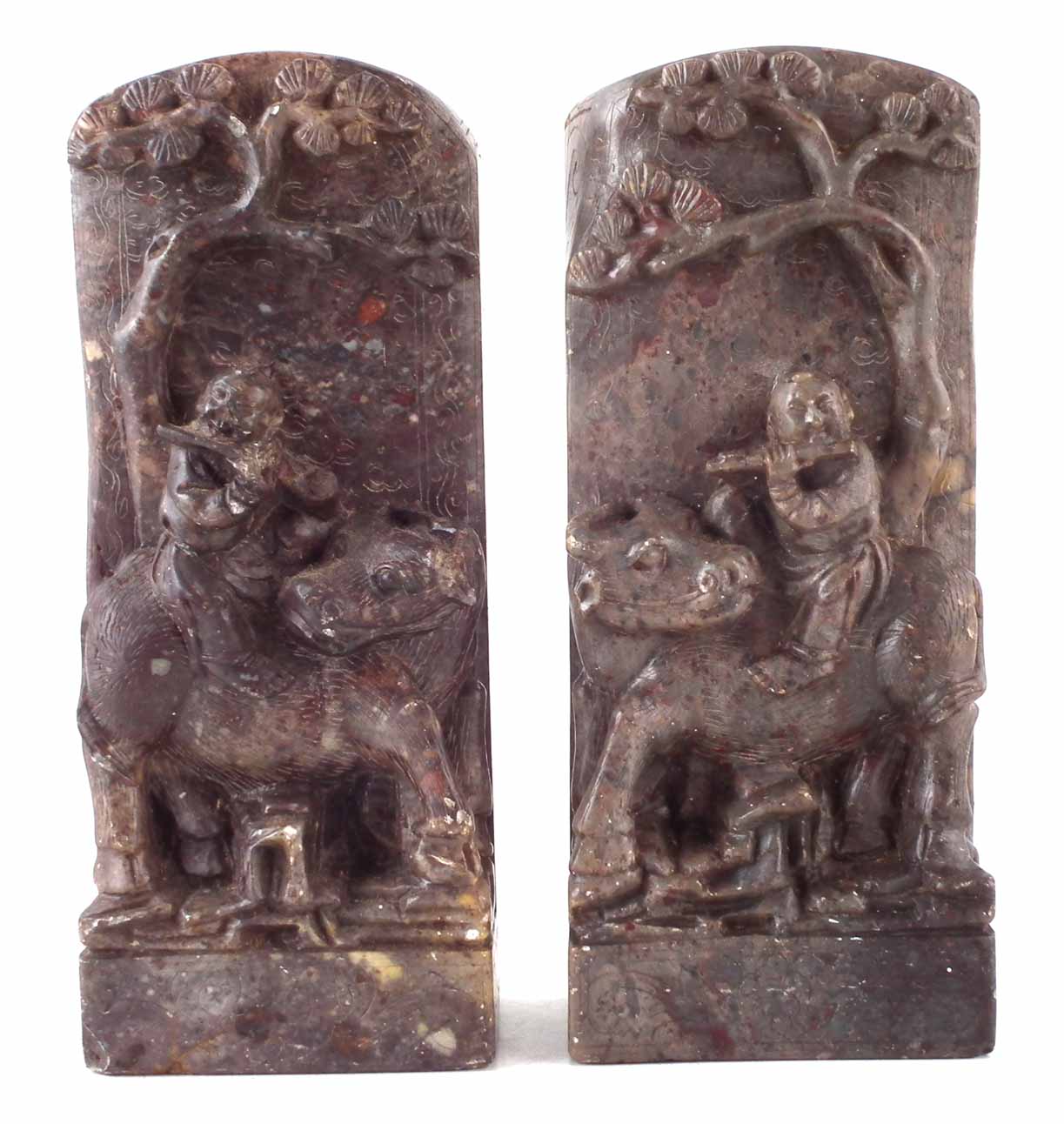 Pair of Chinese soap stone tablets or bookends, carved with boys playing flutes riding buffalos,