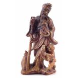 Chinese soapstone figure of a fisherman, modelled with a boy to one side holding a fish and a basket