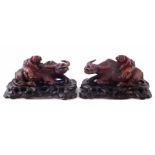 Pair of Chinese hardwood boy and water buffalo figure groups, with applied glass eyes, on pierced