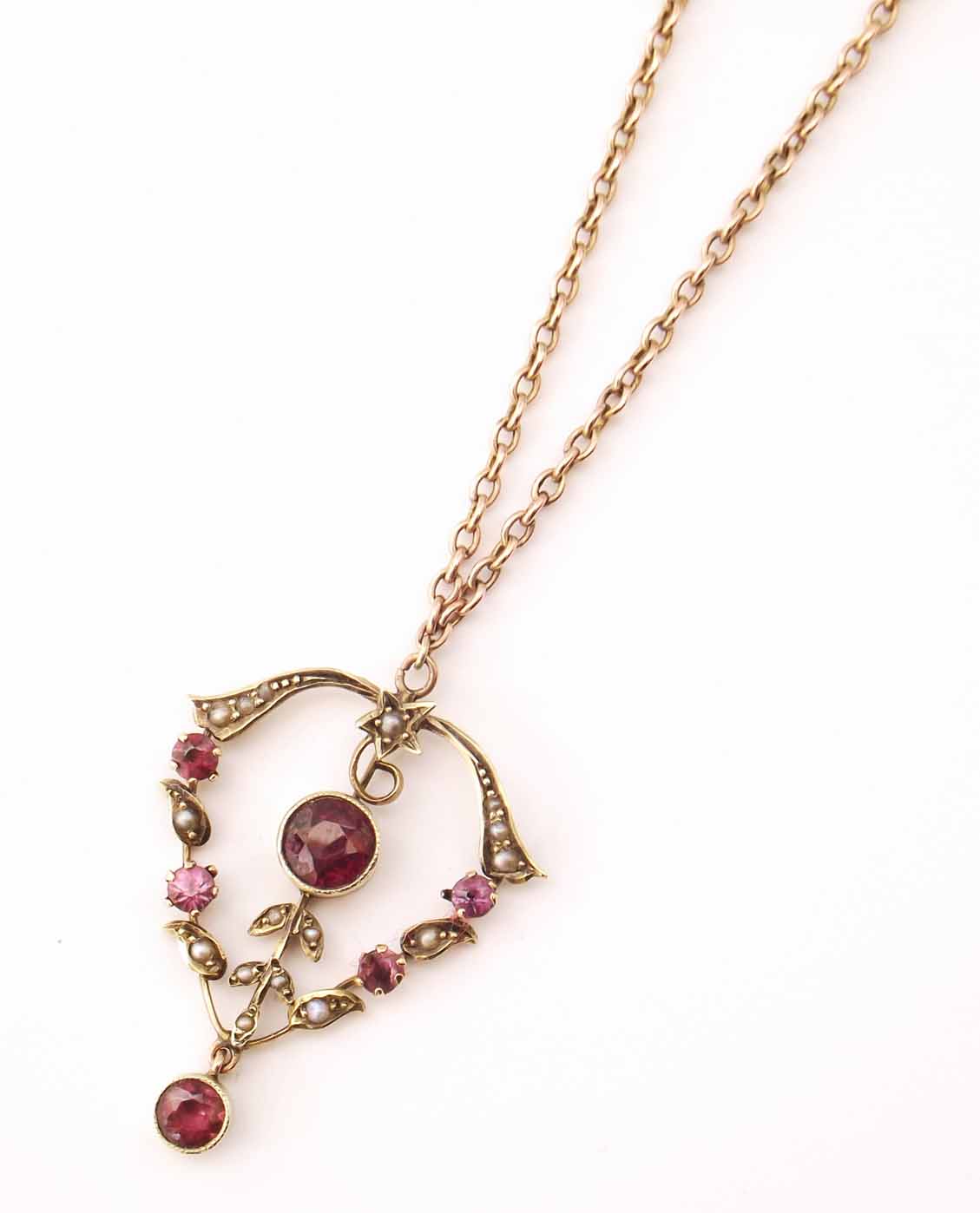 An edwardian 9ct gold pendant, inset with garnets and seed pearls ...