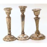 Pair of Birmingham silver candlesticks 15.5cm tall and one similar candlestick.