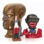 Painted cast iron money bank in the form of a black man, cast iron Napoleon money box and hardwood