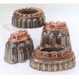 Four copper jelly moulds