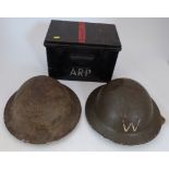 Black metalware box with A.R.P lettering and two wardens helmets