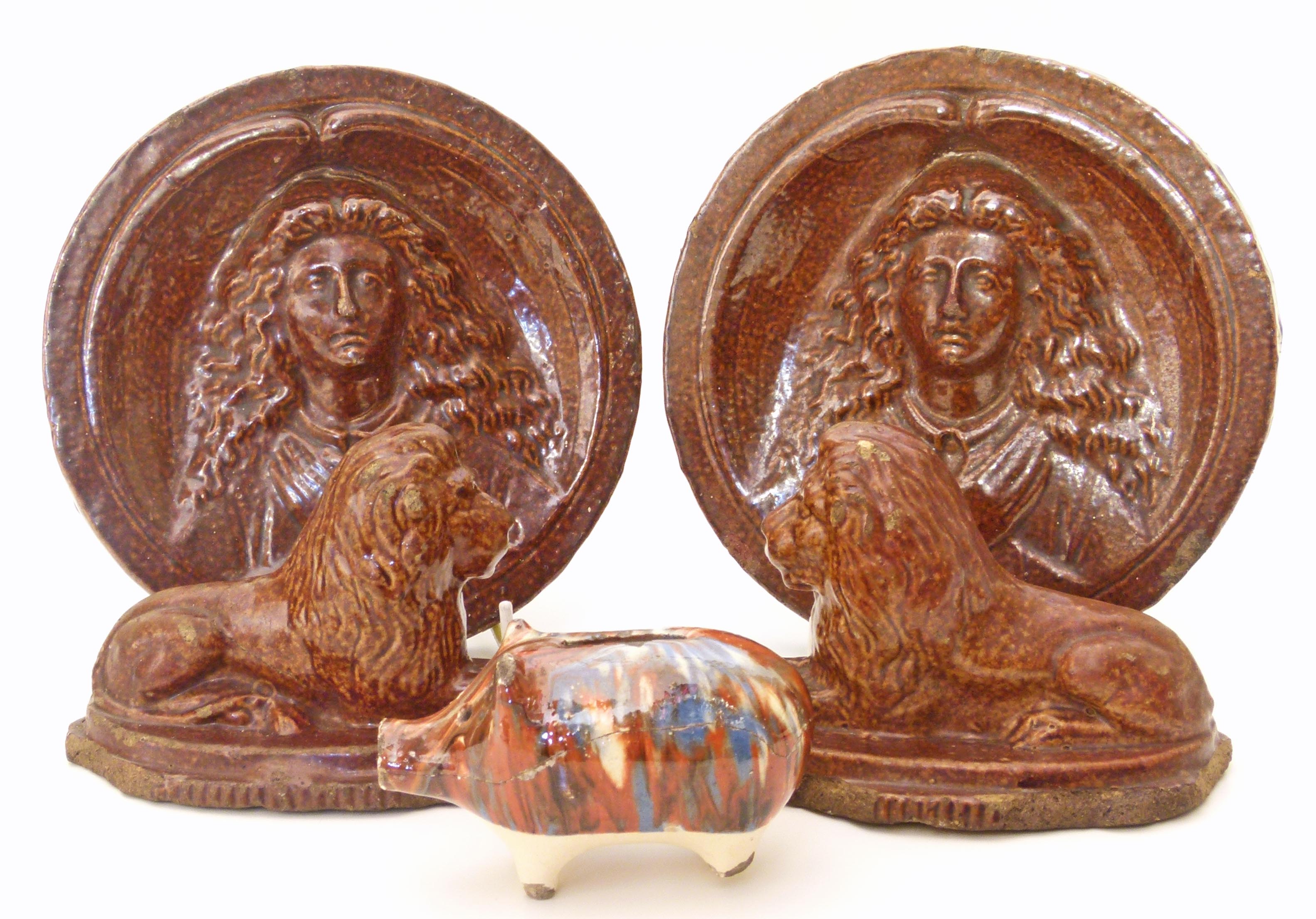 Pair of Victorian salt glaze stoneware Lions and two portrait medallions and a pig money box.