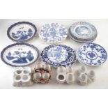 Four porcelain egg stands and eighteen blue and white pottery plates