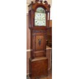 W. Davison Beaumaris long case clock with 8-day movement, painted arched dial and an oak and