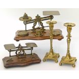 Two sets of brass measuring scales with weights and two brass candlesticks Unfortunately we are