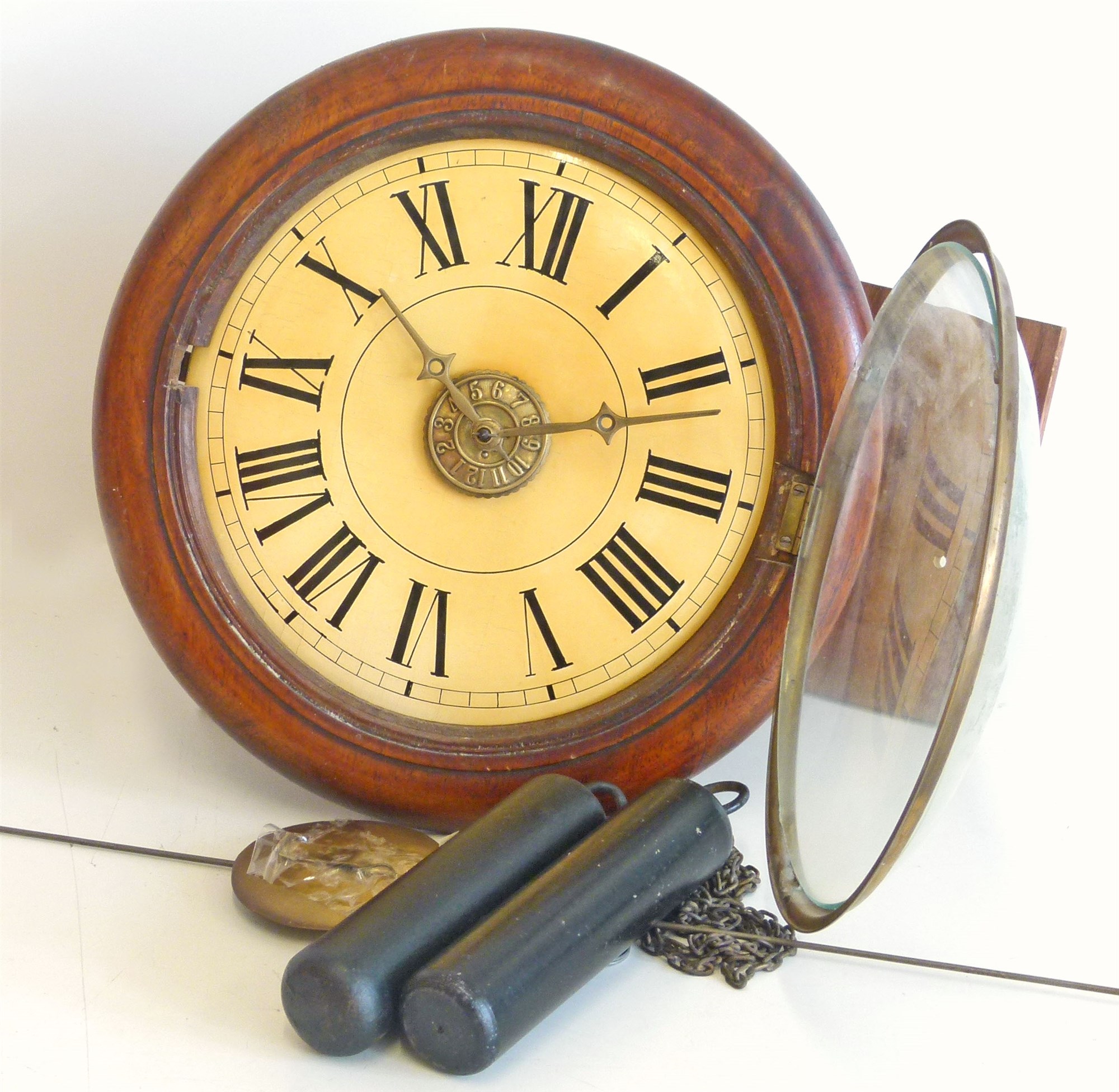 Postman's wall clock. With two brass weights and alarm striking on single bell. 14in diameter.