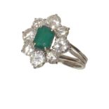 Emerald and diamond oval cluster 18ct white gold ring , central emerald cut emerald in 4-claw