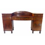 Edwardian mahogany sideboard, two pedestals supporting bow front, drop centre with back board