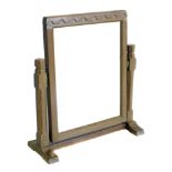 Robert "Mouseman" Thompson dressing table mirror, the oak frame supporting rectangular glass on twin