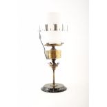 A Victorian 'clock' oil lamp. With white glass shade, acid etched with Roman numerals to denote a