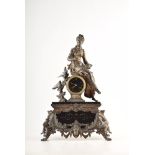 A 19th century French spelter mantel clock. The figure of a lady feeding sparrows is perched above