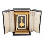 A brass frame Jaeger-LeCoultre carriage clock. With suspended Roman numeral chapter ring framing the