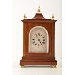 A 20th century mahogany mantel clock with French made movement. Pagoda top, bevelled glass panels,