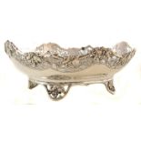 A silver serving dish, rounded rectangular form on four pierced feet in the form of vines, plain