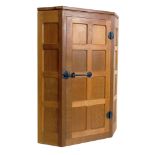 Robert "Mouseman" Thompson corner cupboard, eight panel single door with traditional wrought metal