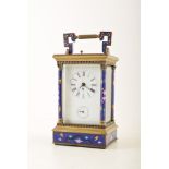 A 19th century brass and cloisonnÃ© carriage clock. The brass frame and Corinthian columns are set