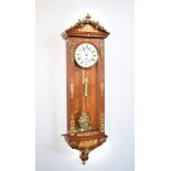 Vienna regulator with oak case. Mounted with gilt wreaths of wild-flowers and fruit. The pointed