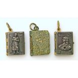 Three small book penants charms, two with pictures of Paris and another with pictures of the Royal